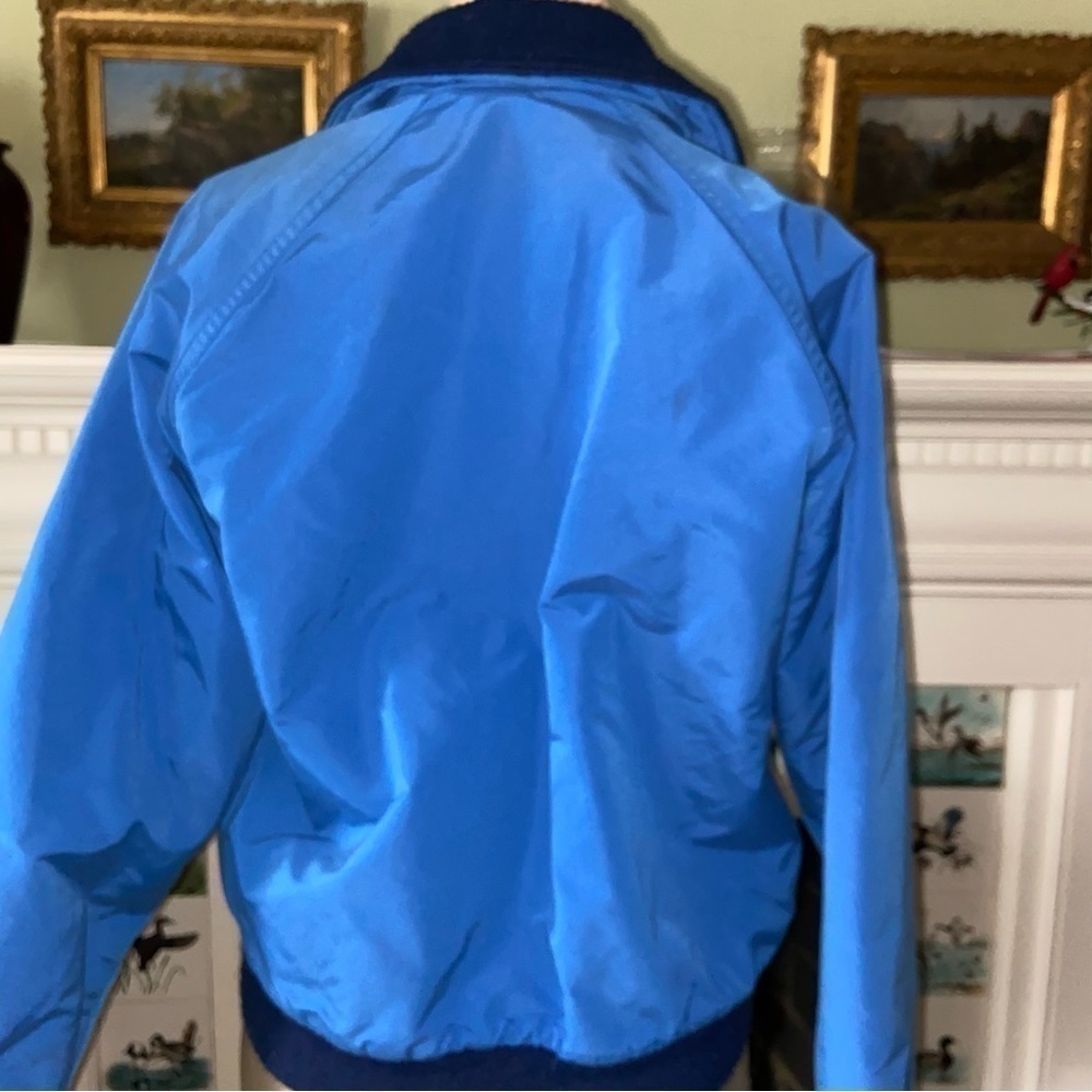 Woolrich warm winter coat has thick fleece lining, soft elastic at cuff and hem.